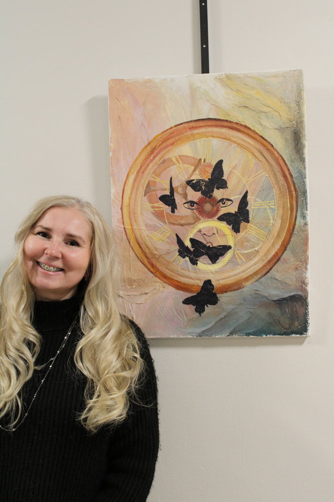Svetlana Askenazy is pictured with her work, titled "Beyond Time."